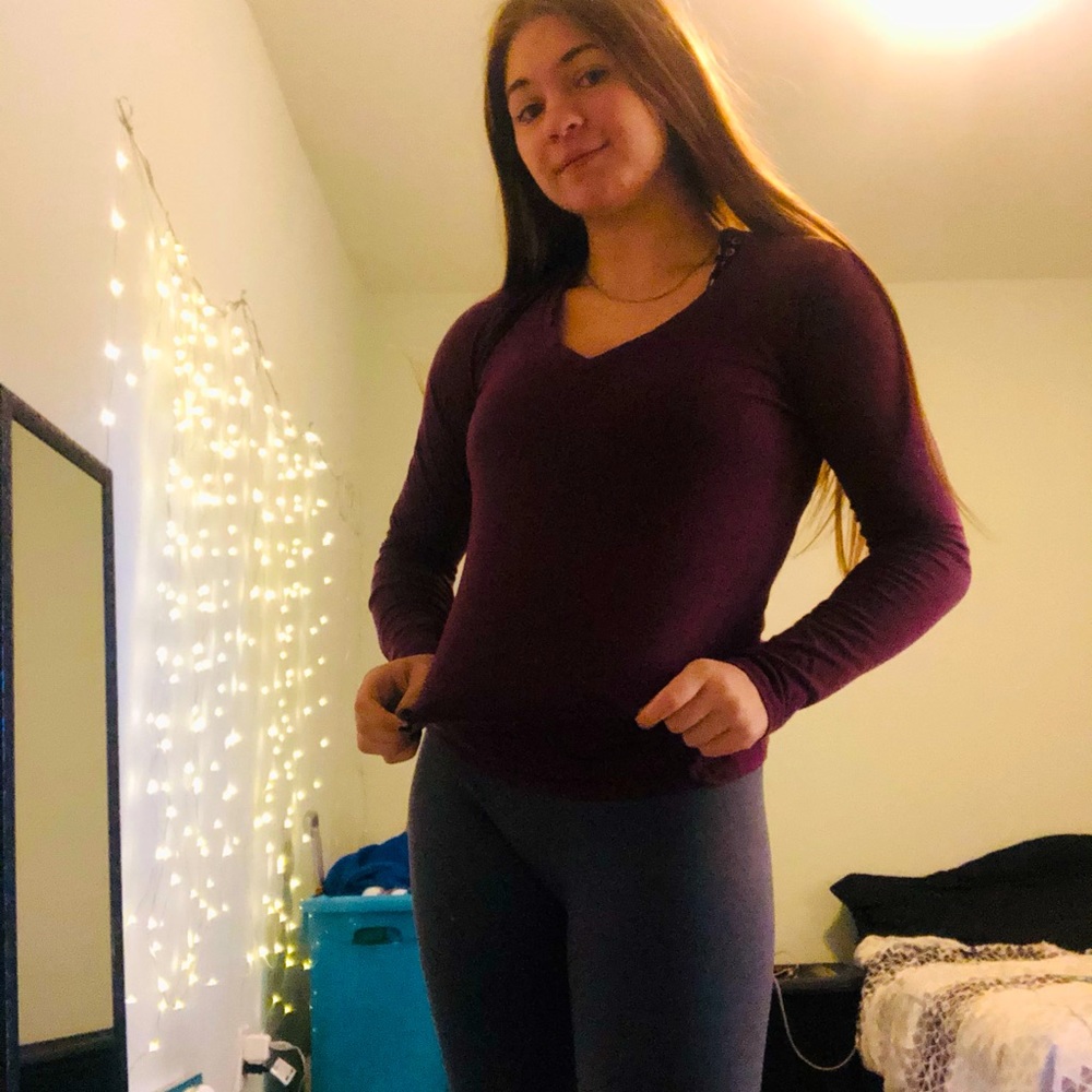 Purple long sleeve size M but fits more like a S. No rips or stains.